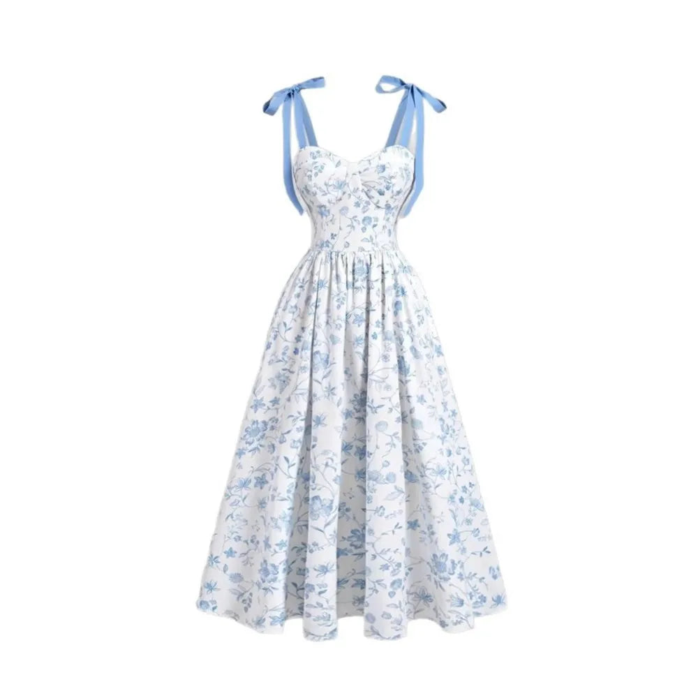 White dress with blue floral pattern and blue straps on a white background