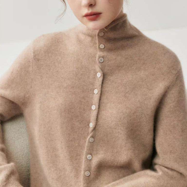A woman wearing a soft, fuzzy high-neck knit sweater in a warm taupe-brown color, featuring a buttoned front closure. The photo is cropped from the chest up, set against a clean, neutral background.