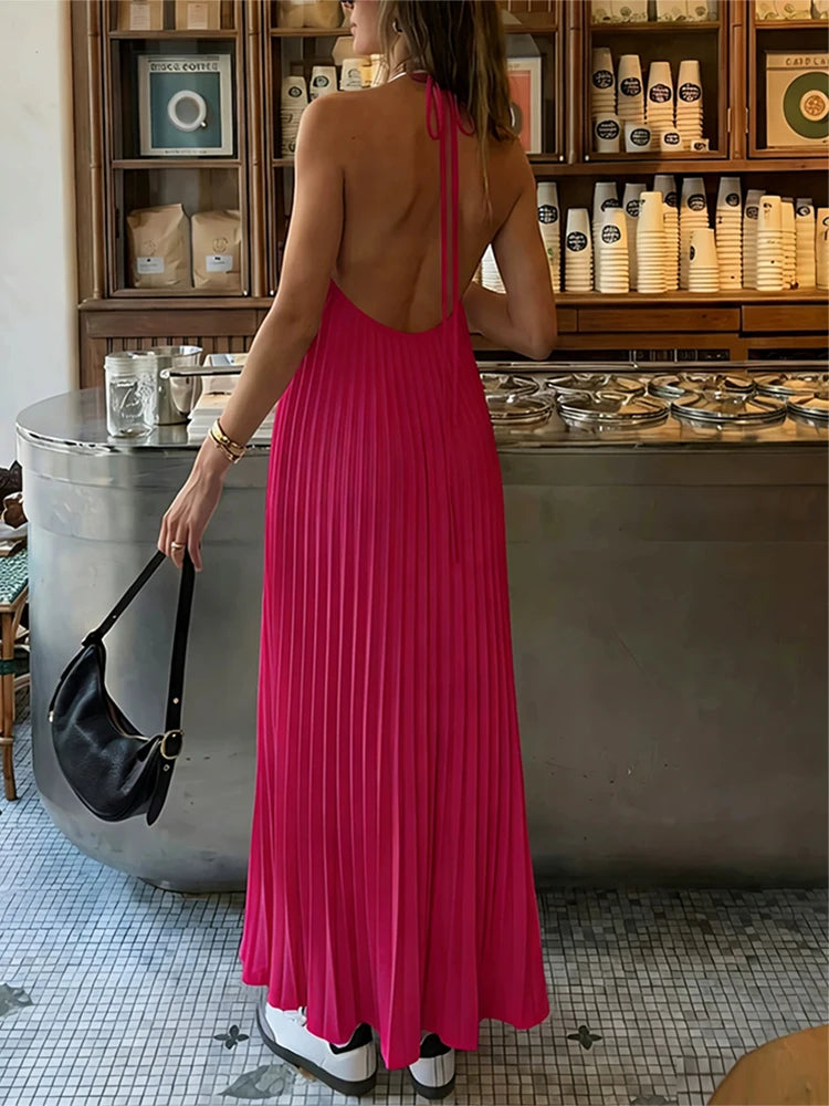 Woman in a pink dress standing in a kitchen setting