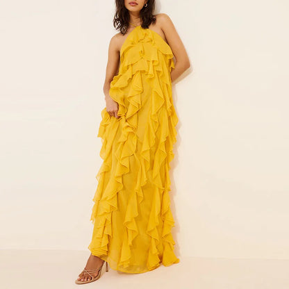 Yellow ruffled dress on a model against a beige background